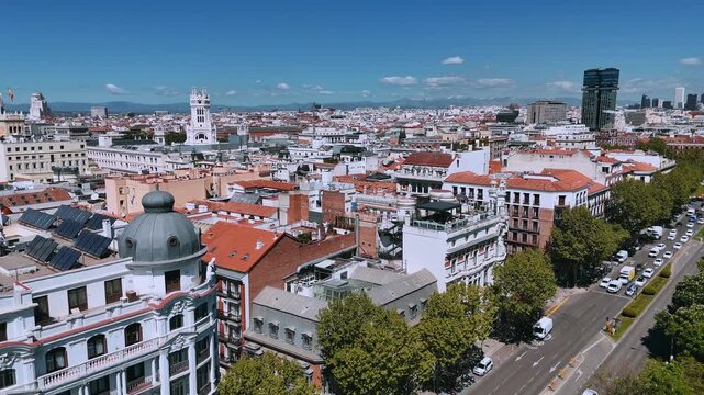 Aerial city view with the Metr&oacute;polis dome and broad Madrid avenue below
