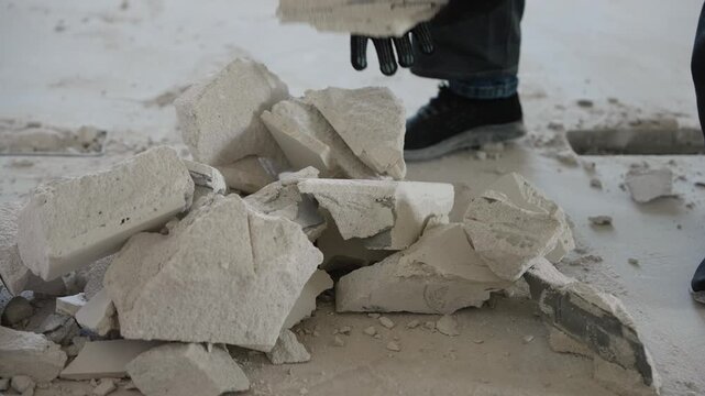 Construction worker removing debris from renovation site