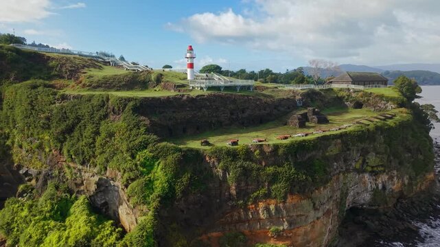 Panoramic aerial view of the canyons of Niebla Castle with its red lighthouse, near Valdivia on a sunny day, southern Chile