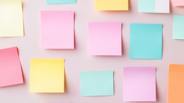 Soft pastel sticky notes scattered on a light pink surface, flat lay. Blank memo pads for ideas, reminders and creative planning, clean background. Stationery, Brainstorm