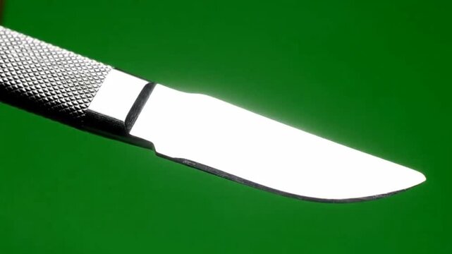 Sharp Surgical Scalpel Blade Tool Close Up On Green Screen Background