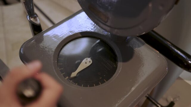 Person Operating Vintage Ship Rudder Angle Indicator and Helm Steering Mechanism in Slow Motion, Historic Maritime Navigation and Nautical Control Equipment