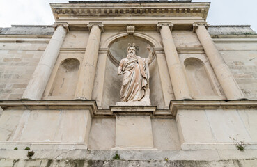 Obraz premium Statue of Moses displayed in a niche framed by four tall columns at Sacro Monte di Varese, a UNESCO World Heritage Site in Lombardy, Italy