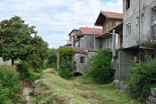 A contrast between traditional stone masonry and modern residential architecture in Tuzi, Montenegro, near the capital city of Podgorica.
