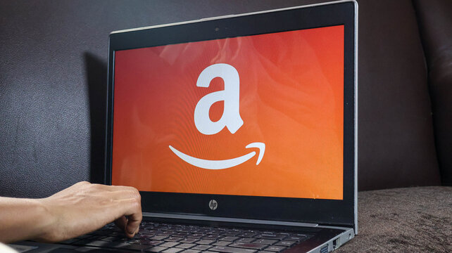 A person interacting with an amazon website on a laptop computer screen