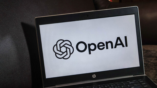 Laptop displaying the openai logo on its screen in a dark setting with hp branding