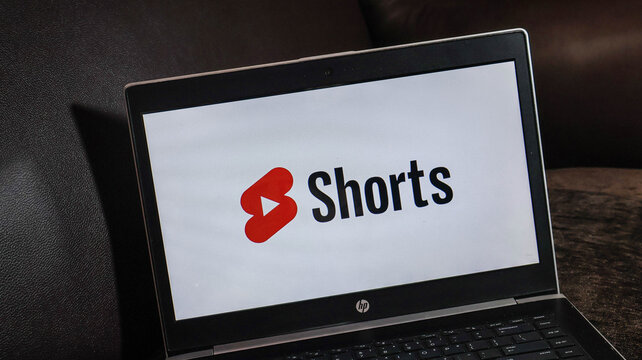 Laptop screen displaying the youtube shorts logo on a dark background with hp laptop