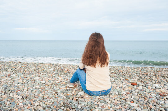 Woman embraces serenity beside ocean