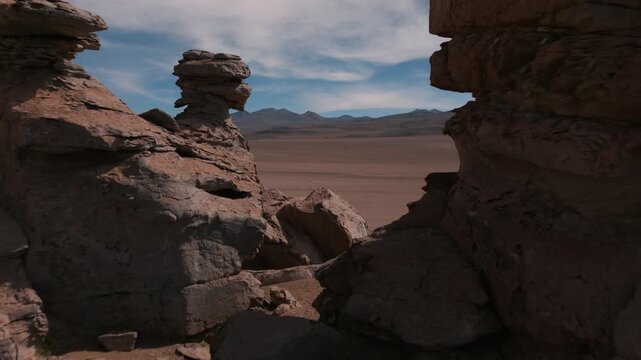Aerial view of eroded rock formations in the Siloli Desert of Bolivia. Volcanic landscapes and vast desert plains create a dramatic Andean scenery.
