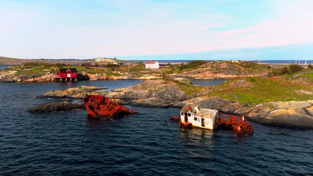 An aerial view of the rocky swedish archipelago coastline featuring several old rusting shipwrecks