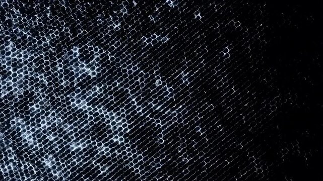 Macro view of textured blue denim fabric revealing detailed weaves in motion