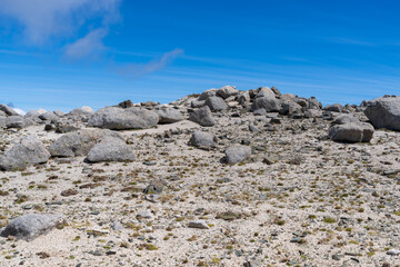 Fototapeta premium Rocky mountain terrain under clear blue sky