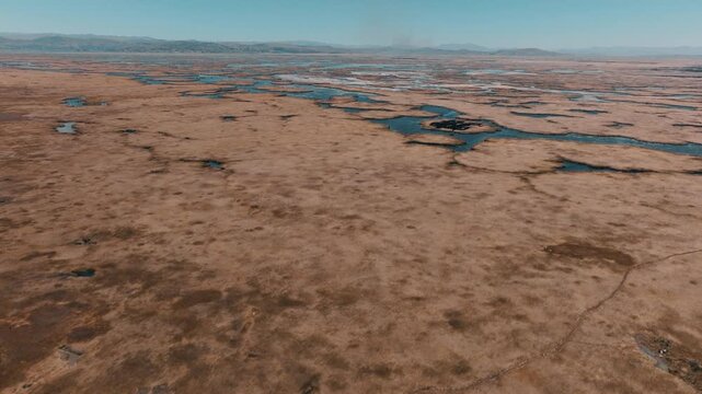 Drone view of the Uros Floating Islands on Lake Titicaca, Peru. Traditional reed islands preserve the unique culture and heritage of the Uros people.