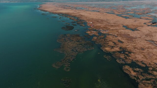 Drone view of the Uros Floating Islands on Lake Titicaca, Peru. Traditional reed islands preserve the unique culture and heritage of the Uros people.