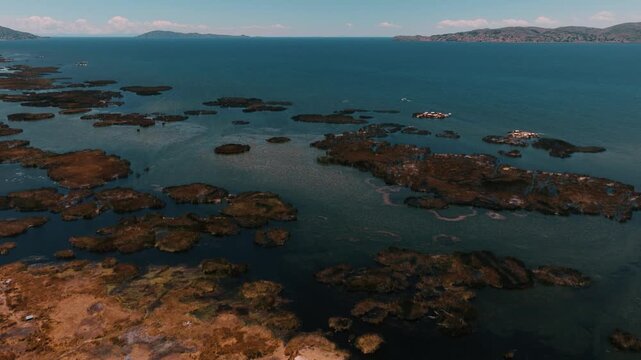 Drone view of the Uros Floating Islands on Lake Titicaca, Peru. Traditional reed islands preserve the unique culture and heritage of the Uros people.