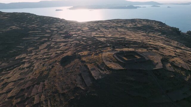 Drone view of ancient agricultural terraces overlooking Lake Titicaca on Isla del Sol, one of Bolivia&rsquo;s most iconic cultural landscapes.