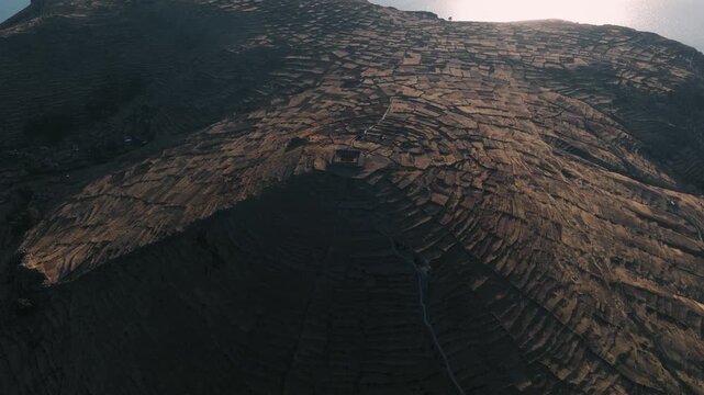 Drone view of ancient agricultural terraces overlooking Lake Titicaca on Isla del Sol, one of Bolivia&rsquo;s most iconic cultural landscapes.