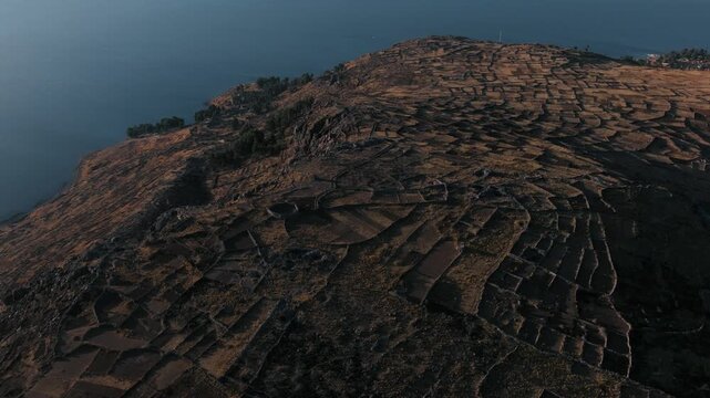 Drone view of ancient agricultural terraces overlooking Lake Titicaca on Isla del Sol, one of Bolivia&rsquo;s most iconic cultural landscapes.