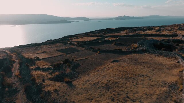 Drone view of ancient agricultural terraces overlooking Lake Titicaca on Isla del Sol, one of Bolivia&rsquo;s most iconic cultural landscapes.