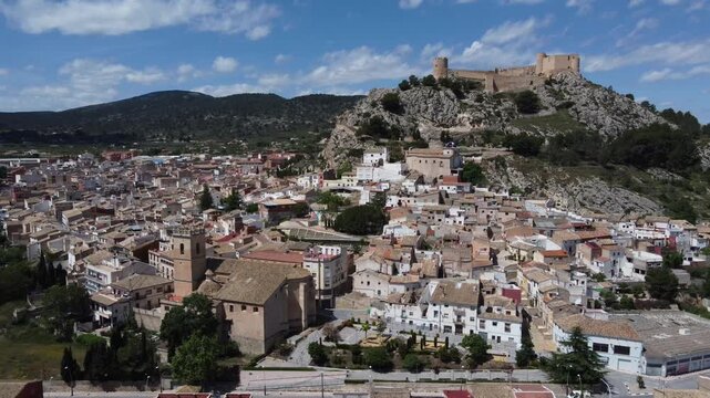 Orbiting around the old town and castle of Castalla, Spain. Church of Our Lady of the Assumption in the foreground.