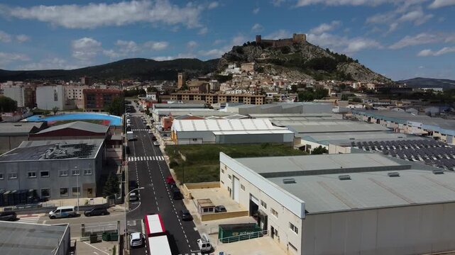 Flying over the Castalla industrial estate towards the Islamic castle and old town. Spain.