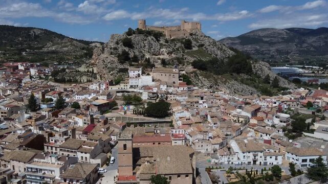 Flying over the old town towards the islamic castle on top of the hill. Castalla, Spain.