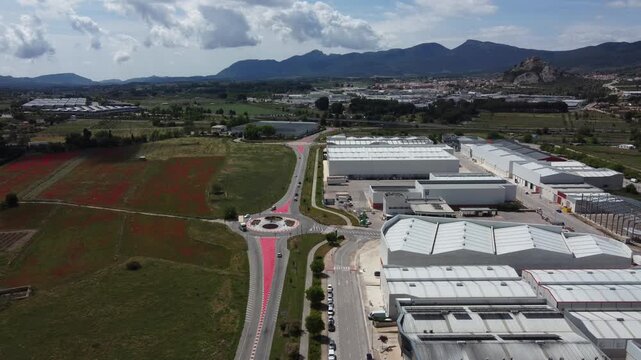 Aerial view of the La Marjal Industrial Estate, surrounded by farmland, with the town of Castalla in the background. Spain.