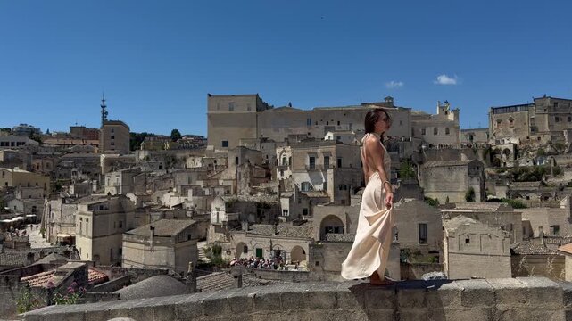 Elegant Woman Walking with Panoramic View of Sassi di Matera Italy UNESCO World Heritage Historic City