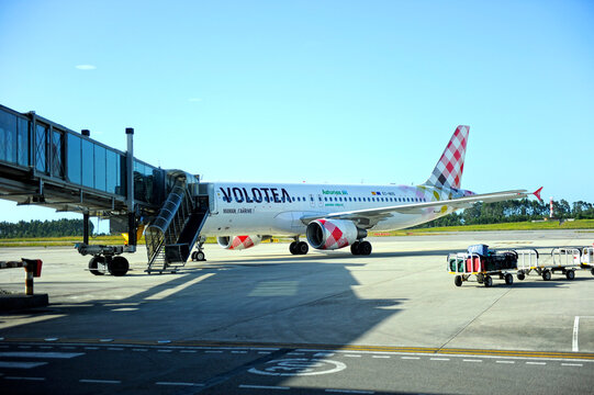 Passenger boarding bridge for an Airbus aircraft belonging to the Spanish low-cost airline Volotea on the runway at Asturias Airport. Principado of Asturias, northern Spain.