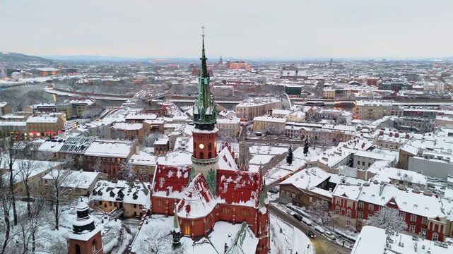 An aerial flyover of St. Joseph's Cathedral in Krakow at sunset in winter in Poland.

