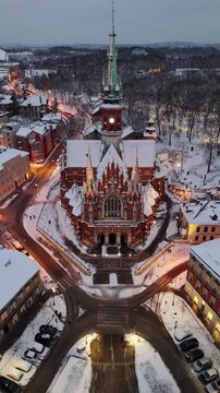 An aerial flyover of St. Joseph's Cathedral in Krakow at sunset in winter in Poland.

