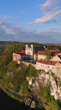  Aerial flyover of an abbey on a river in Poland at sunset in spring
