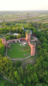 Aerial flyover of castle ruins in Poland at sunset in spring

