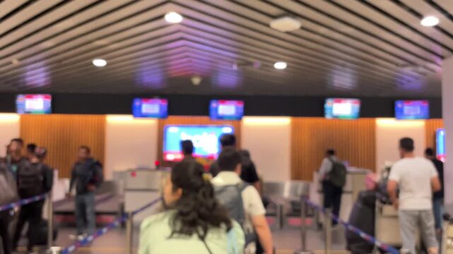 Passengers queue to board a plane at the airport terminal. Blur video.	