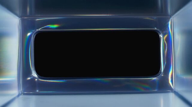 Slow push in close up of rectangular glass aperture with shifting light refractions and iridescent highlights on studio tabletop backdrop