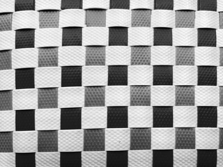Obraz premium Black and White Checkerboard Woven Plastic Texture, High Contrast Geometric Grid Pattern, Minimal Abstract Basketry Square Surface Background