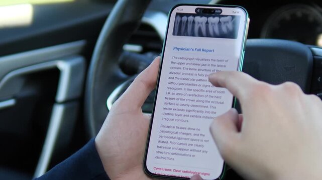 POV of a patient reviewing dental imaging and a diagnostic report inside a car. The screen shows a clear conclusion of dental caries with red highlighting. Great for showcasing healthcare