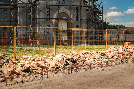 construction site with scaffolding and rubble near historic building restoration