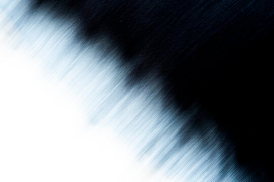 Dramatic diagonal ICM motion blur transitioning from slate blue light to midnight black shadow. High contrast fluid texture with an impressionistic feel for minimalist creative design.