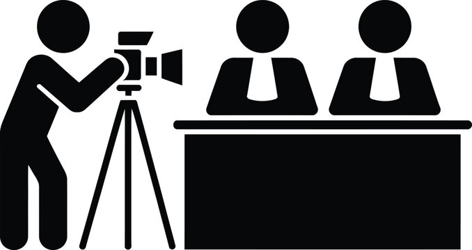 Professional camera operator filming two interviewers at a desk