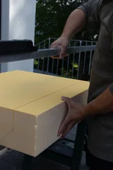 craftsman cutting the insulation board with styrofoam cutter © Brilliant Eye
