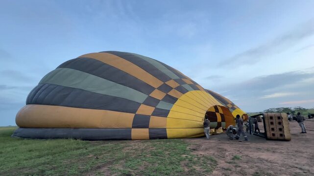 Filling a hot air balloon before takeoff in Serengeti National Park. Tanzania.