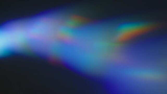 Slow motion panning shot of colorful light refractions drifting across dark gradient background with soft bokeh and shifting iridescent hues