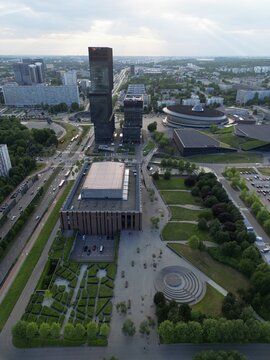 Vertical high angle aerial drone view of the modern Culture Zone in Katowice, Poland, featuring the KTW skyscrapers, NOSPR concert hall, and the iconic Spodek arena.