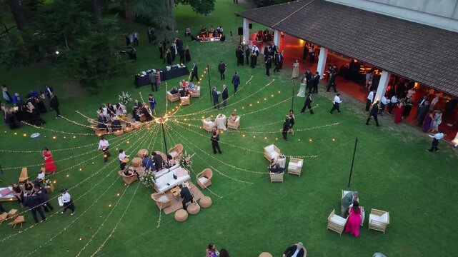 Evento social en una estancia al atardecer con gente celebrando, casamiento, festejo, festividad, reuni&oacute;n al aire libre, ambiente campestre y celebraci&oacute;n elegante