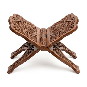 Ornate carved wooden Quran stand for holy book, traditional folding rehal book holder, carved wood Islamic religious artifact on white background