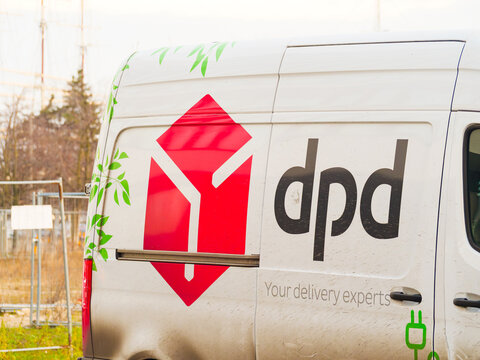 DPD logo on delivery truck, logistics shipping company courier electric vehicle with sign, 18 December 2025, Poland