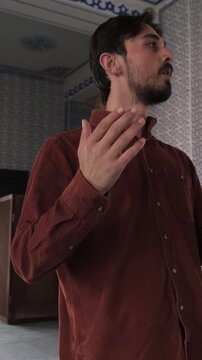 Man Standing In Mosque Praying