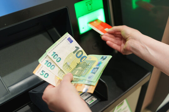 Euro banknotes withdrawn from ATM while payment card remains inserted