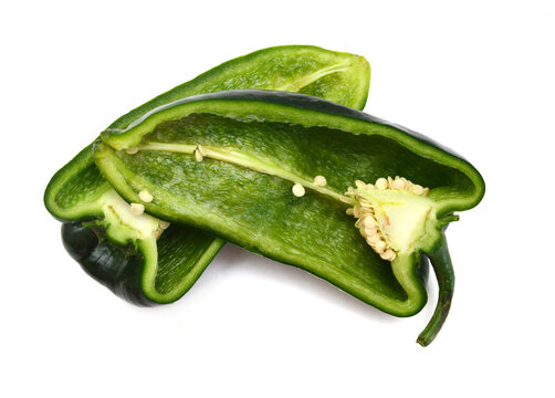 Stack dark green poblano peppers isolated on white